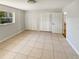Bright bedroom featuring tile floors, closet, window, and white walls at 1155 Galahad Dr, Casselberry, FL 32707