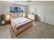 Cozy bedroom features a large bed, natural light, and a minimalist aesthetic with light wood furniture at 1155 Galahad Dr, Casselberry, FL 32707