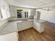 Renovated kitchen with white cabinets, granite countertops, and a breakfast bar at 1155 Galahad Dr, Casselberry, FL 32707