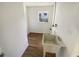 Bright laundry room featuring a utility sink, wood-look floors, and a window for natural light at 1155 Galahad Dr, Casselberry, FL 32707