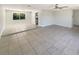 Bright living room showcasing a ceiling fan, neutral walls, and tile flooring at 1155 Galahad Dr, Casselberry, FL 32707