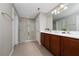 Bathroom featuring double sinks, white countertops, a shower, and tile flooring at 11916 Fiore Dr, Orlando, FL 32827