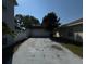 Long driveway leading to a detached garage, providing ample parking space at 1233 Hancock Cir, St Cloud, FL 34769