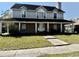 Charming two-story home with a inviting front porch, showcasing its classic architectural design at 1233 Hancock Cir, St Cloud, FL 34769