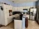 Spacious kitchen with white cabinets, black countertops, and stainless steel refrigerator at 1233 Hancock Cir, St Cloud, FL 34769