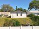Rear view of home showing the lawn with a white fence at 13820 Adams St, Grand Island, FL 32735