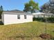 Backyard with well-maintained lawn and simple landscaping at 13820 Adams St, Grand Island, FL 32735