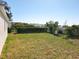 View of the backyard with manicured lawn and privacy hedges at 13820 Adams St, Grand Island, FL 32735
