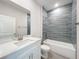 Well-lit bathroom features a white vanity with marble countertop and a tiled shower-tub combo at 13820 Adams St, Grand Island, FL 32735