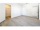 Spacious bedroom featuring modern wood-look floors and a large walk-in closet at 13820 Adams St, Grand Island, FL 32735
