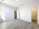Neutral bedroom featuring modern wood-look floors and a walk-in closet at 13820 Adams St, Grand Island, FL 32735