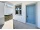 The front door is blue with white trim and a window near the entrance at 13820 Adams St, Grand Island, FL 32735