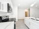 Another view of the kitchen with white cabinets and stainless appliances at 13820 Adams St, Grand Island, FL 32735