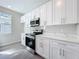 Kitchen featuring stainless steel stove, microwave and white cabinets at 13820 Adams St, Grand Island, FL 32735