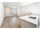 Close-up of a kitchen island with marble countertops and a stainless steel sink at 13820 Adams St, Grand Island, FL 32735