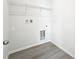 Bright laundry room with vinyl floors and wire shelf at 13820 Adams St, Grand Island, FL 32735