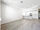 Bright living room with wood floors, modern lighting, and a kitchen area at 13820 Adams St, Grand Island, FL 32735