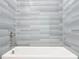 Close-up view of the tiled shower and white tub combination at 13820 Adams St, Grand Island, FL 32735