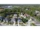 Aerial view of a quiet neighborhood with two-story homes, mature trees, and a community pond nearby at 1421 Arbitus Cir, Oviedo, FL 32765