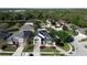 An aerial view of a neighborhood featuring a two-story home with a lawn and nearby pond at 1421 Arbitus Cir, Oviedo, FL 32765