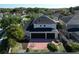 Birds eye view of rear exterior with a patio area and lush landscaping, plus solar panels on the roof at 1421 Arbitus Cir, Oviedo, FL 32765