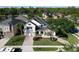 Aerial view of a two-story home with well-maintained landscaping, lawn, stone accents and nearby pond at 1421 Arbitus Cir, Oviedo, FL 32765