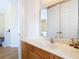 Bathroom with wood vanity, marble countertop, and large mirror at 1421 Arbitus Cir, Oviedo, FL 32765