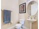 Cozy bathroom featuring a pedestal sink, round mirror, and decorative artwork at 1421 Arbitus Cir, Oviedo, FL 32765