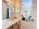 Bathroom featuring double vanity and doorway leading to bedroom at 1421 Arbitus Cir, Oviedo, FL 32765