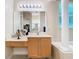 Bright bathroom with a vanity and makeup counter, columns, a large mirror, and tile flooring at 1421 Arbitus Cir, Oviedo, FL 32765