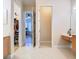 Bright bathroom with open doorways, tile flooring, a vanity, and an entrance to a walk-in closet at 1421 Arbitus Cir, Oviedo, FL 32765