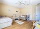 Comfortable bedroom featuring a twin bed, seating area, and a ceiling fan under natural light at 1421 Arbitus Cir, Oviedo, FL 32765