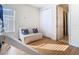 Well-lit bedroom boasts a loft bed, loveseat, and a closet, illuminated by natural light at 1421 Arbitus Cir, Oviedo, FL 32765