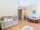 Bright bedroom featuring wood floors, neutral walls, and a comfortable seating area at 1421 Arbitus Cir, Oviedo, FL 32765
