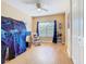 Bright bedroom featuring a play tent, gliding rocking chair, and natural light under a ceiling fan at 1421 Arbitus Cir, Oviedo, FL 32765