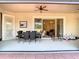 Covered patio with an outdoor dining set, connecting to a staircase and living area inside at 1421 Arbitus Cir, Oviedo, FL 32765