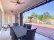 Enjoy this covered patio with ceiling fans and an outdoor dining area, overlooking a large brick backyard at 1421 Arbitus Cir, Oviedo, FL 32765