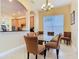 Lovely dining room off the kitchen provides a glass table with seating for six at 1421 Arbitus Cir, Oviedo, FL 32765