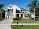 Charming two-story home featuring a lush, landscaped front yard, stone accents and a brick driveway at 1421 Arbitus Cir, Oviedo, FL 32765