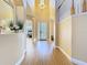 Bright foyer with decorative glass front door and beautiful wood-look flooring and staircase at 1421 Arbitus Cir, Oviedo, FL 32765