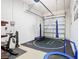 Finished garage space with workout equipment and padded flooring at 1421 Arbitus Cir, Oviedo, FL 32765
