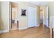 Hallway with wood floors and multiple doors leading to other rooms of the home at 1421 Arbitus Cir, Oviedo, FL 32765