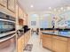 Kitchen with granite countertops, stainless steel appliances, a central island, and light colored cabinets at 1421 Arbitus Cir, Oviedo, FL 32765