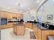 Wide kitchen angle with granite countertops, a central island, light colored cabinets, and stainless steel appliances at 1421 Arbitus Cir, Oviedo, FL 32765