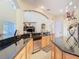 Open kitchen with black granite countertops, stainless steel appliances and a breakfast bar at 1421 Arbitus Cir, Oviedo, FL 32765