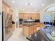 Kitchen with stainless steel appliances, a central island, and an open design at 1421 Arbitus Cir, Oviedo, FL 32765