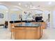 Kitchen island with a granite countertop and a wooden base, offering seating and storage at 1421 Arbitus Cir, Oviedo, FL 32765