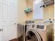 Laundry room featuring modern washer and dryer set with white cabinets at 1421 Arbitus Cir, Oviedo, FL 32765