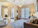 Living room featuring chandelier, neutral paint, lots of windows, and comfortable furniture at 1421 Arbitus Cir, Oviedo, FL 32765