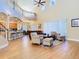 Open concept living room with high ceilings, lots of windows, and wood floors at 1421 Arbitus Cir, Oviedo, FL 32765
